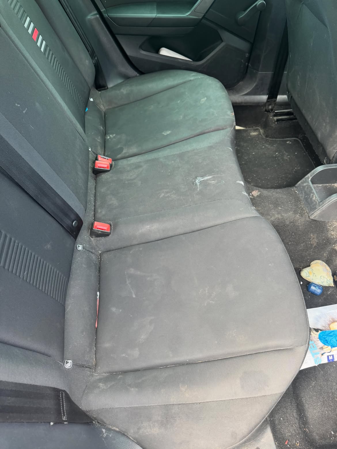 Rear seat bench before cleaning, fabric marked and stained