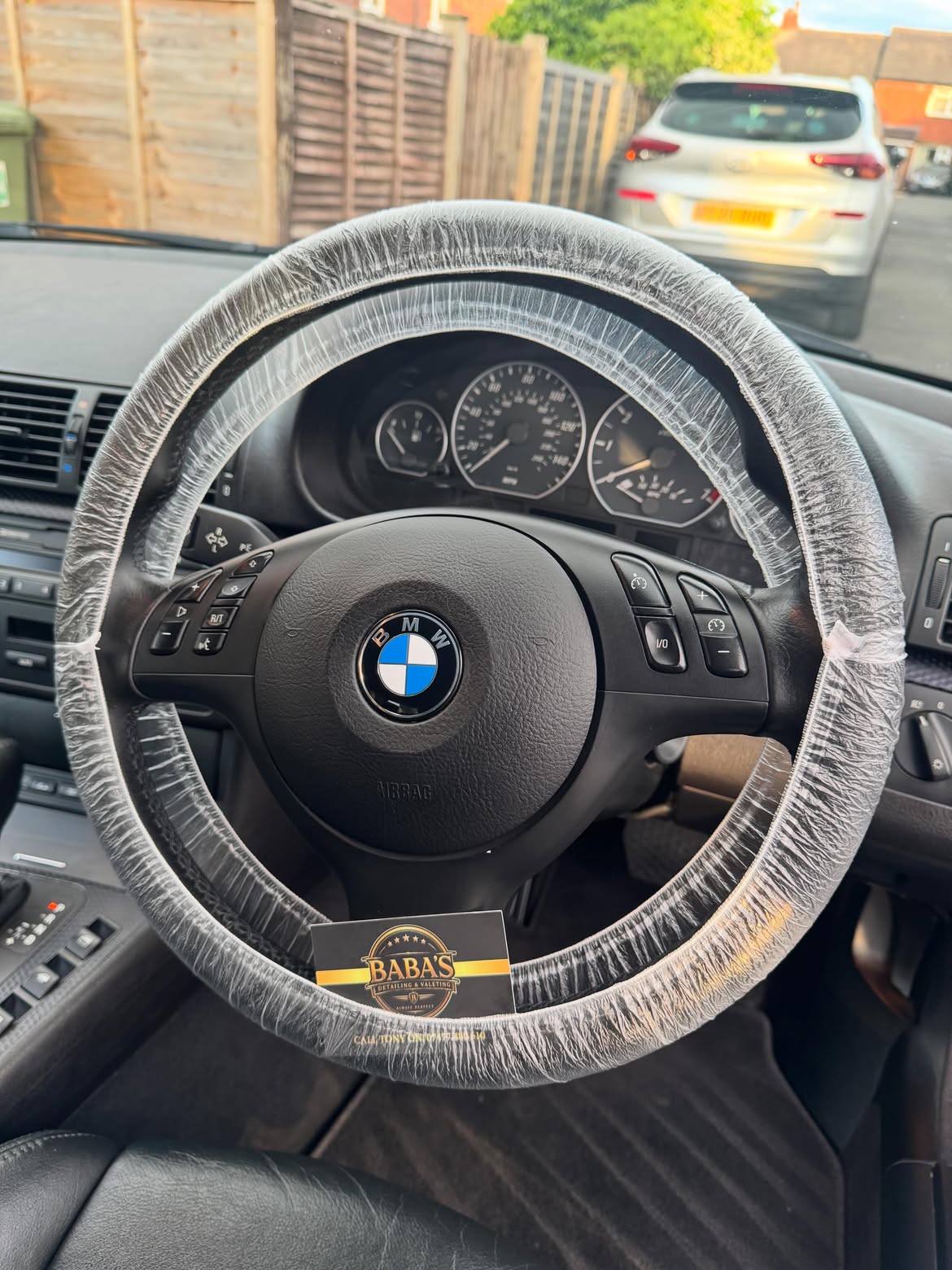 Protected steering wheel and cleaned interior of a BMW E46 with Baba's Detailing card